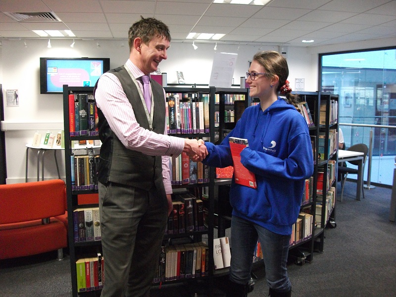 The 'Pyeong Chang 2018 Winter Olympics Quiz' winner being presented with her prize by Jim Temple the Library Manager.